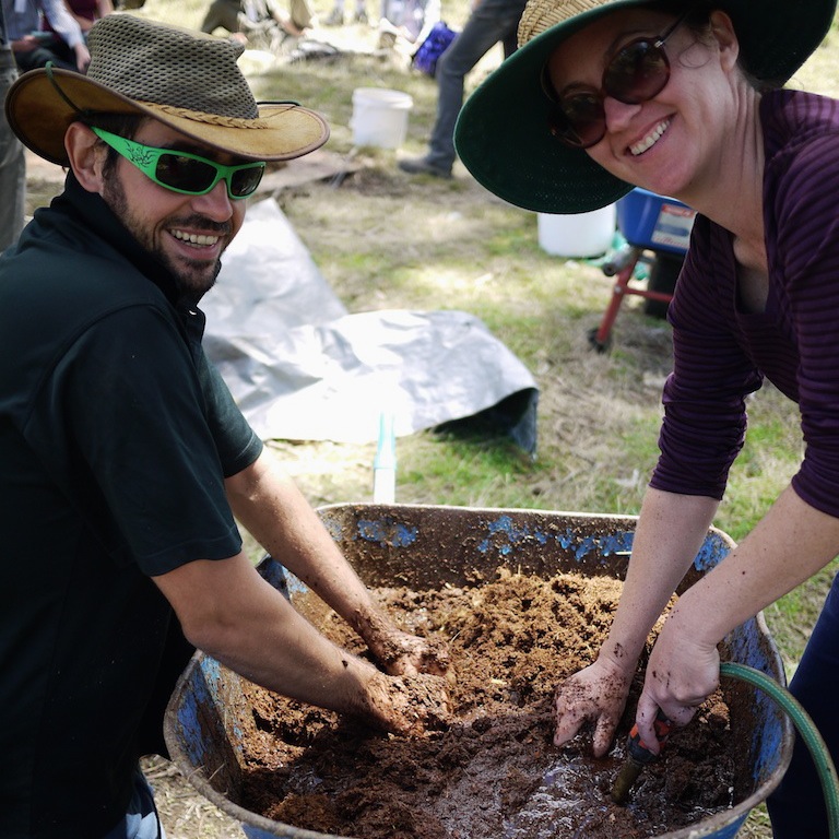 Henry and Karen making a nice cow-poo slurry to add to the compost pile being made