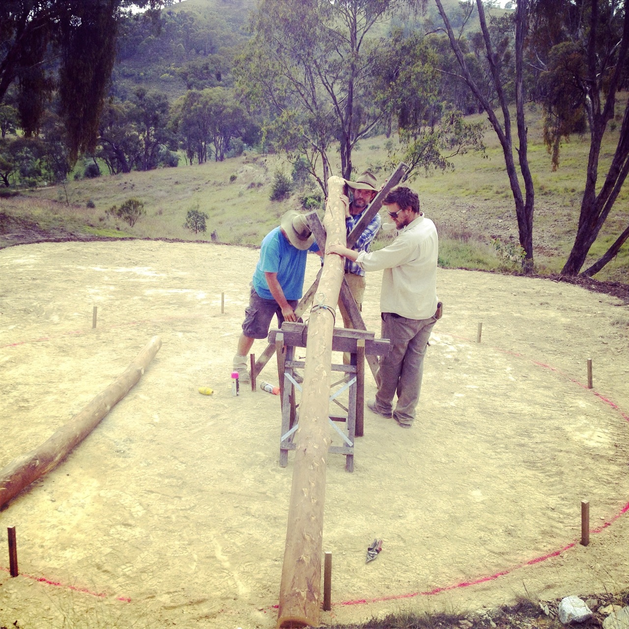 Shane, Nick and Floyd practicing making our reciprocal roof on the ground... to check we had everything right.